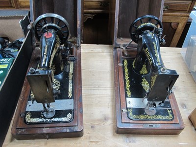 Lot 1202 - Two Wooden-Cased Singer Sewing Machines...