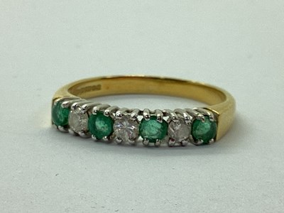 Lot 102 - An 18ct Gold Emerald and Diamond Half Eternity...