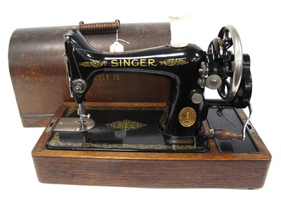 Lot 1232 - A Wooden-cased Singer No.99 Sewing Machine...