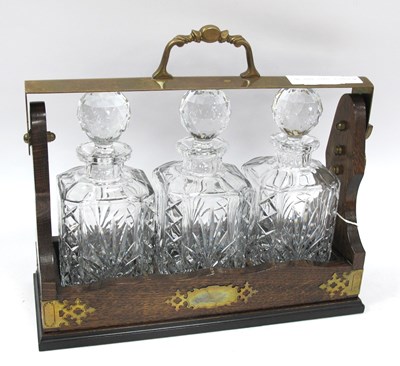 Lot 1521 - Oak Tantalus with brass mounts and a fall...