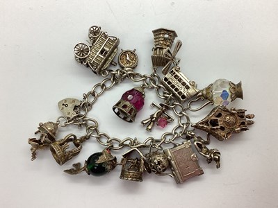 Lot 213 - A Curb Link Charm Bracelet, to hallmarked...
