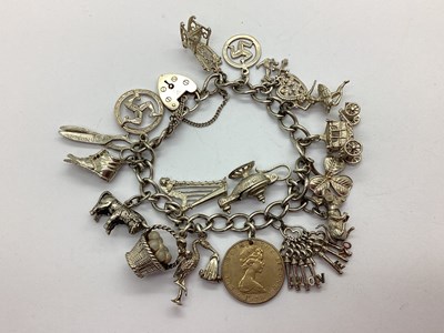 Lot 218 - A Curb Link Charm Bracelet, to hallmarked...