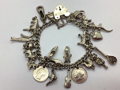Lot 211 - A Curb Link Charm Bracelet, to hallmarked...