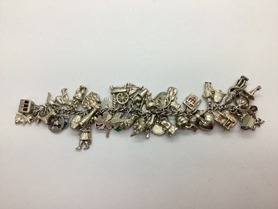 Lot 217 - A Curb Link Charm Bracelet, (lacking clasp)...
