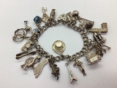 Lot 214 - A Double Curb Link Charm Bracelet, to...
