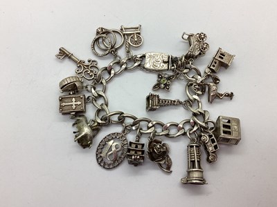 Lot 219 - A Curb Link Charm Bracelet, to snap clasp,...
