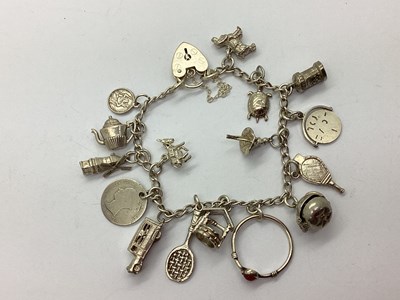 Lot 204 - A Curb Link Charm Bracelet, to heart shape...