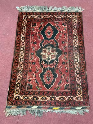 Lot 1664 - Middle Eastern Wool Tassled Rug, with central...