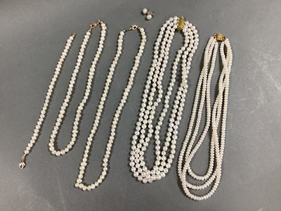 Lot 210 - A Three Strand Pearl Bead Necklace, knotted...
