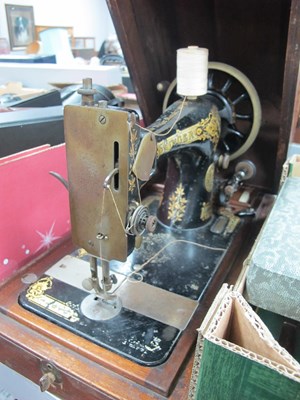 Lot 1063 - A Singer Sewing Machine, (cased).