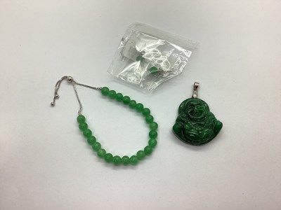 Lot 197 - A Modern Polished Carved Buddha Pendant,...