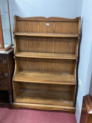 Lot 1679 - Ercol Waterfall Bookcase with a shaped top,...