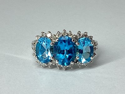 Lot 71 - A Blue Topaz and Diamond Triple Cluster Ring,...