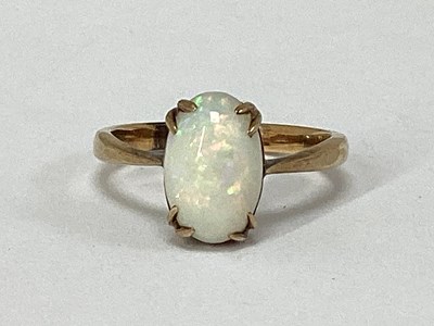 Lot 54 - An Opal Single Stone Dress Ring, oval cabochon...