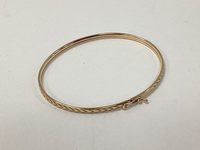 Lot 96 - A Dainty Hollow Textured Bangle, with chevron...