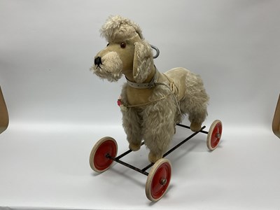Lot 834 - A Mid XX Steiff Ride on Poodle, overall...