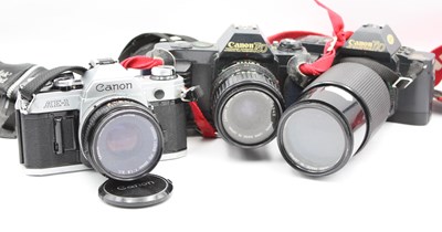 Lot 1385 - Three Canon SLR cameras: Canon AE-1 with Canon...