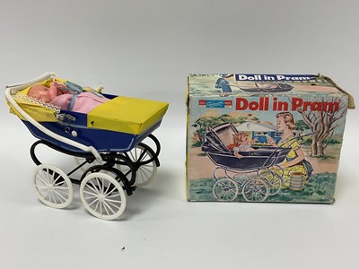 Lot 929 - A Telsada #25082 plastic doll in pram, with...