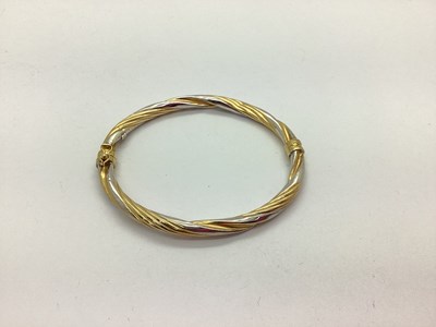 Lot 83 - A Modern Hollow Two Colour Hinged Bangle,...