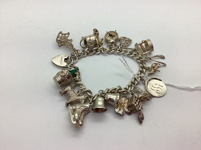 Lot 110 - A Curb Link Charm Bracelet, to hallmarked...
