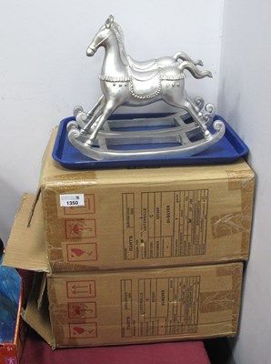 Lot 1350 - Two boxed silvery decorative rocking horse...