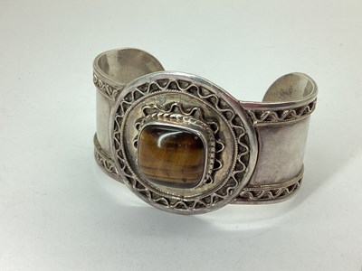 Lot 104 - A Tiger's Eye Inset Wide Cuff Bangle, cushion...