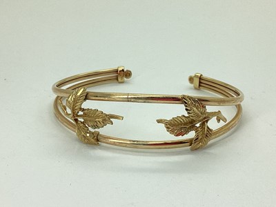 Lot 78 - A 9ct Gold Openwork Bangle, with applied leaf...