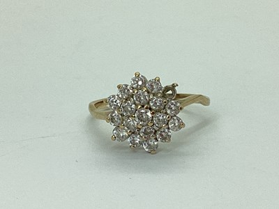 Lot 41 - A Modern Cluster Ring, claw set throughout...