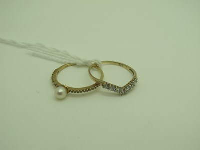 Lot 331 - A Modern Dainty Pearl Dress Ring, between claw...