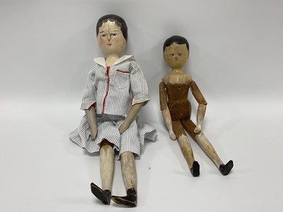 Lot 915 - Two Folk Art Wooden Dolls, both with carved...