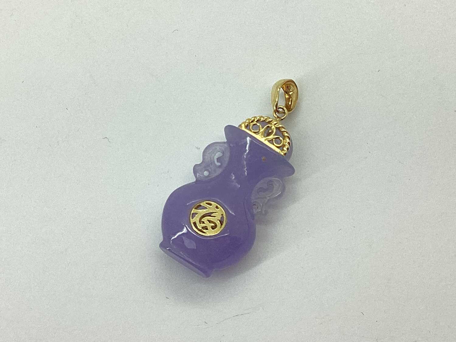 Lot 68 - A Lavender Jade Coloured Carved Vase Pendant,...