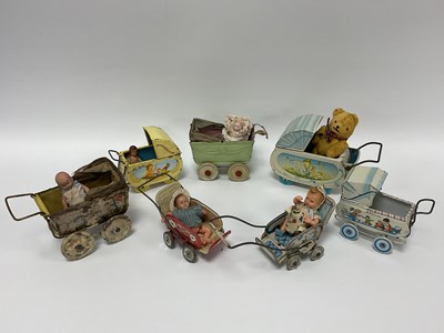 Lot 918 - Seven Mid XX Century Tinplate Toy Prams, by...