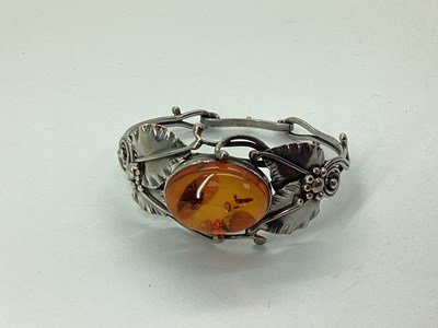Lot 93 - An Amber Inset Openwork Bangle, oval collet...