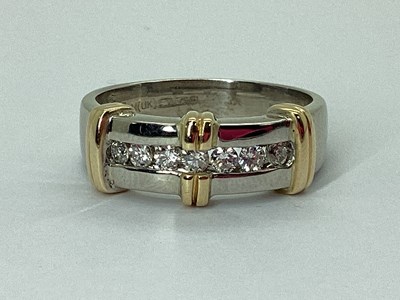 Lot 221 - A Modern Diamond Set Ring, two tone channel...