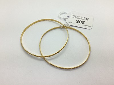 Lot 205 - A Pair of Textured Bangles, stamped "10ct". (2)