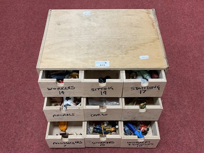 Lot 413 - A wooden chest containing nine drawers each...