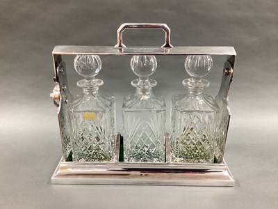 Lot 1 - A Three Bottle Plated Tantalus, of plain...