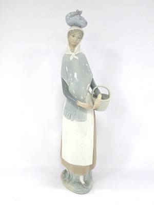 Lot 1183 - Lladro Lady Holding a Basket, 34cm tall.