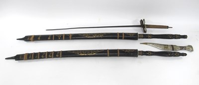 Lot 1326 - Two oriental short swords with wooden...