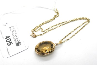 Lot 405 - A Citrine Single Stone Pendant, oval collet...