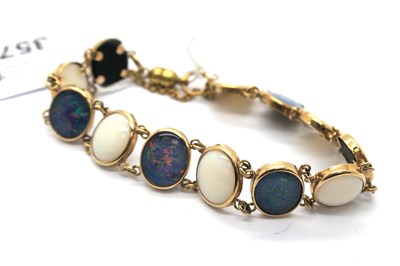 Lot 357 - A Modern 9ct Gold Black and White Opal Panel...