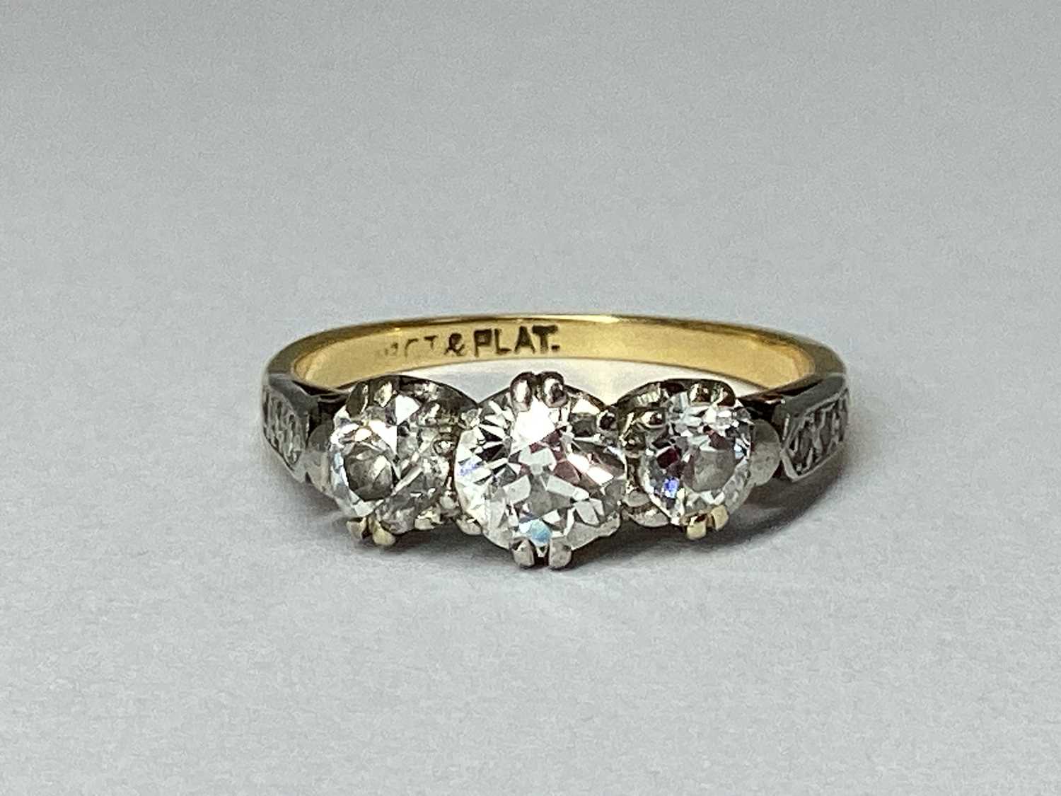 Lot 78 - A Three Stone Diamond Ring, claw set, between...