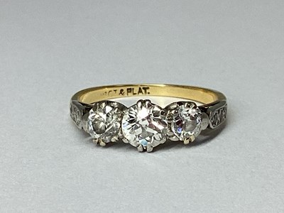 Lot 78 - A Three Stone Diamond Ring, claw set, between...