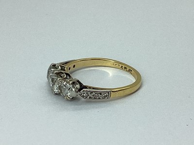 Lot 78 - A Three Stone Diamond Ring, claw set, between...
