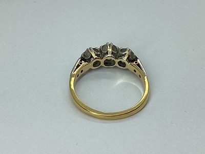 Lot 78 - A Three Stone Diamond Ring, claw set, between...