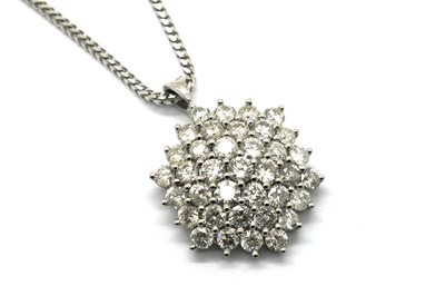Lot 385 - A Large Diamond Set Cluster Pendant, claw set...