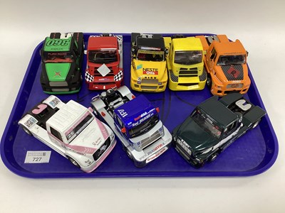 Lot 727 - Eight 1:32 scale slot racing trucks. Liveries...