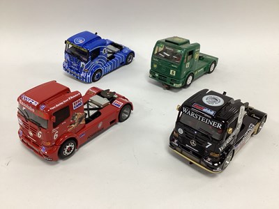 Lot 733 - Four 1:32 scale slot racing trucks. All...