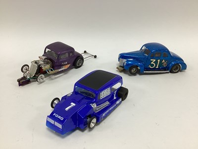 Lot 702 - Three 1:24 scale slot cars. All with an...