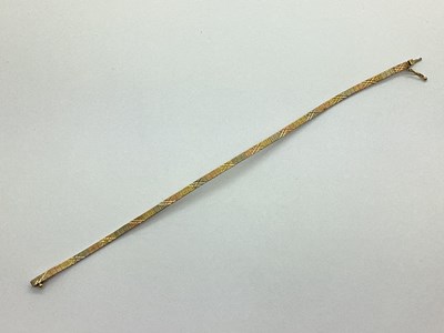 Lot 105 - A Flat Link Tri-Colour Bracelet, of textured...